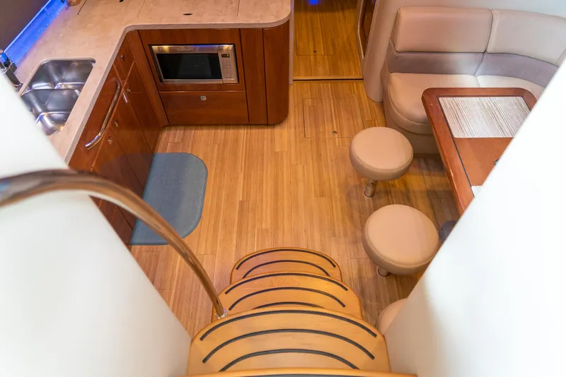Slide: The Image of Interior of 2016 Formula 45 Yacht with kitchen and seating area, featuring wooden flooring. - 30
