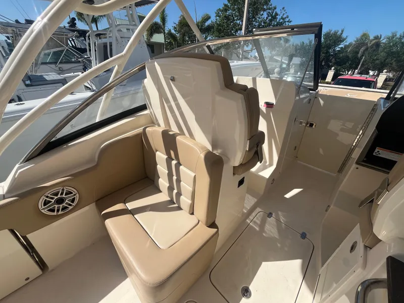 Slide: The Image of 2023 Scout 255 Dorado boat interior with beige seating and modern design. - 10