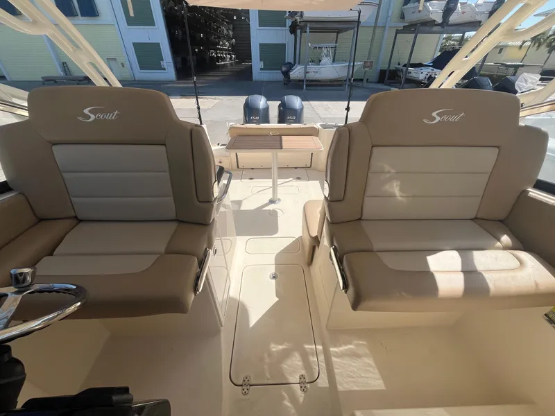 Slide: The Image of 2023 Scout 255 Dorado boat interior with dual seating and steering wheel. - 15