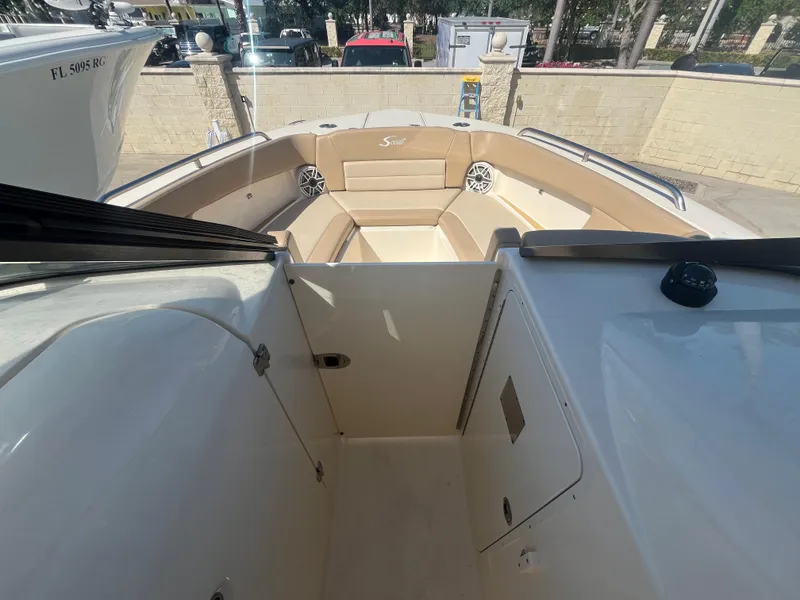 Slide: The Image of 2023 Scout 255 Dorado boat interior with beige seating and modern design. - 17