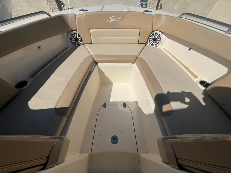 Slide: The Image of 2023 Scout 255 Dorado boat interior with beige seating and speakers. - 19
