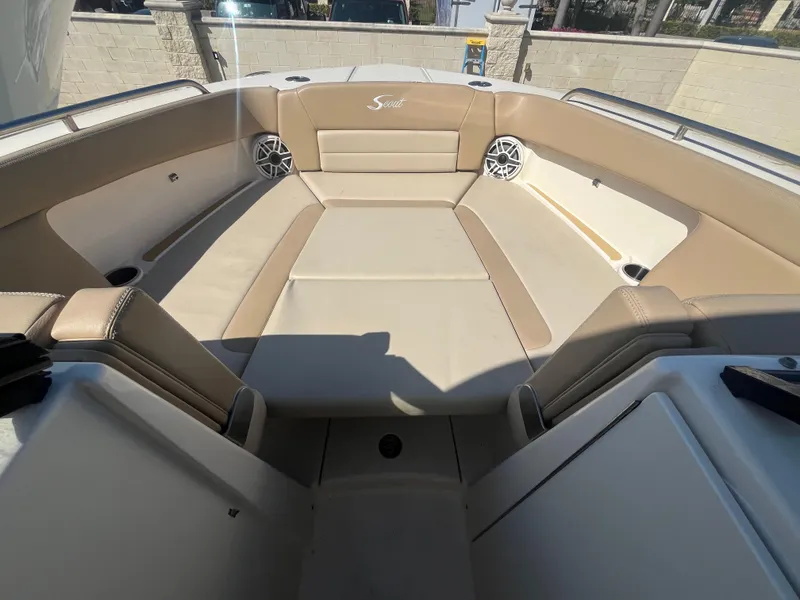 Slide: The Image of 2023 Scout 255 Dorado boat interior with beige seating and speakers. - 20