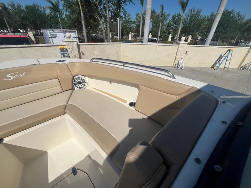 Slide: The Image of 2023 Scout 255 Dorado boat interior with beige seating and speaker. - 22