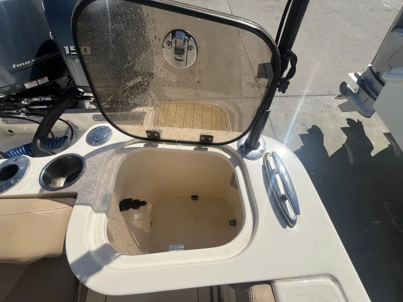 Slide: The Image of 2023 Scout 255 Dorado boat with open storage compartment and cup holders. - 27