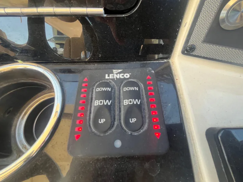 Slide: The Image of 2023 Scout 255 Dorado boat control panel with Lenco trim tab switches. - 28
