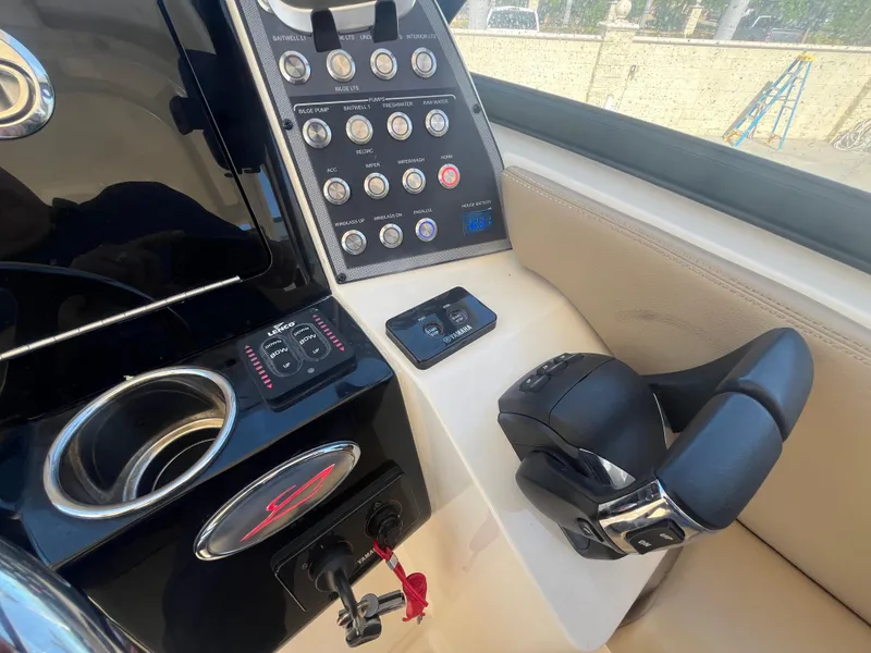 Slide: The Image of 2023 Scout 255 Dorado boat dashboard with control panel and steering wheel. - 30