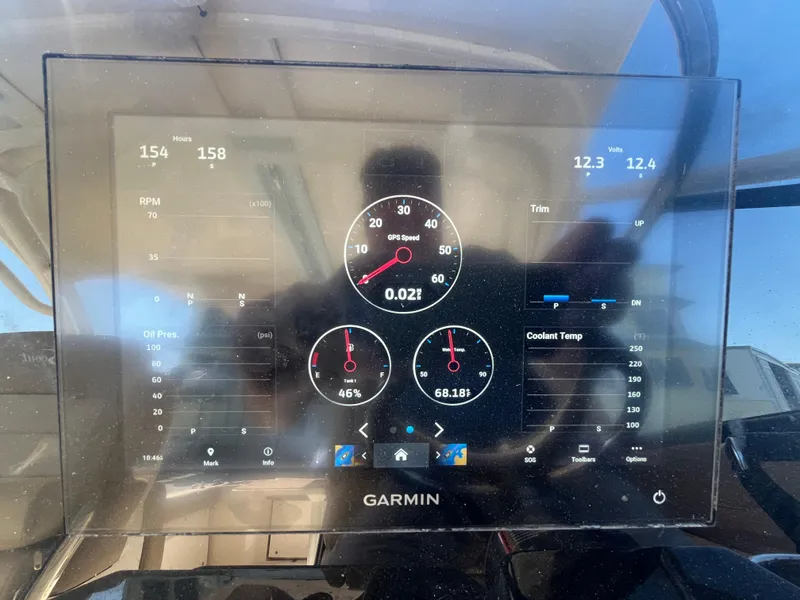 Slide: The Image of Garmin display on 2023 Scout 255 Dorado boat showing speed, RPM, and temperature gauges. - 33