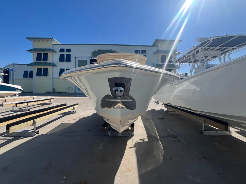 Slide: The Image of 2023 Scout 255 Dorado boat on display under clear blue sky. - 4