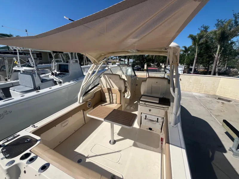 Slide: The Image of 2023 Scout 255 Dorado boat with canopy, spacious deck, and seating area. - 7