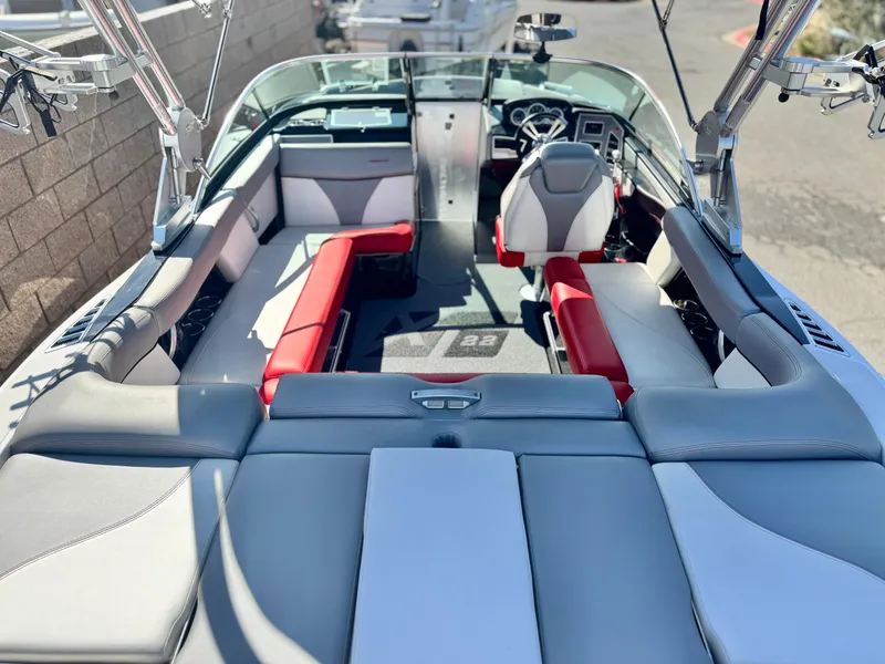 Slide: The Image of 2018 MasterCraft XT22 boat interior with red and gray seating, sleek design. - 11