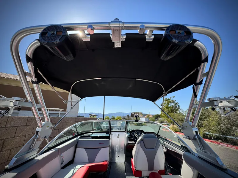 Slide: The Image of 2018 MasterCraft XT22 boat interior with canopy and seating, showcasing modern design and comfort. - 12