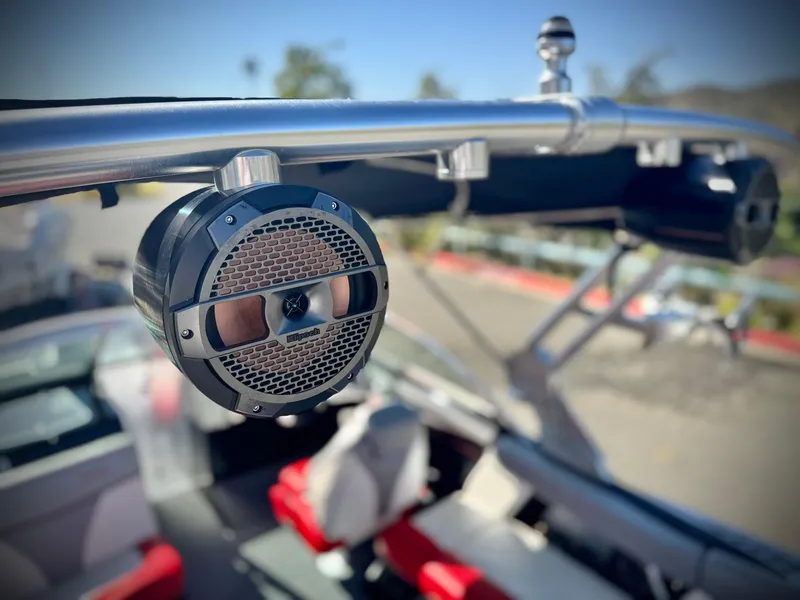 Slide: The Image of 2018 MasterCraft XT22 boat with mounted speaker and sleek interior design. - 13