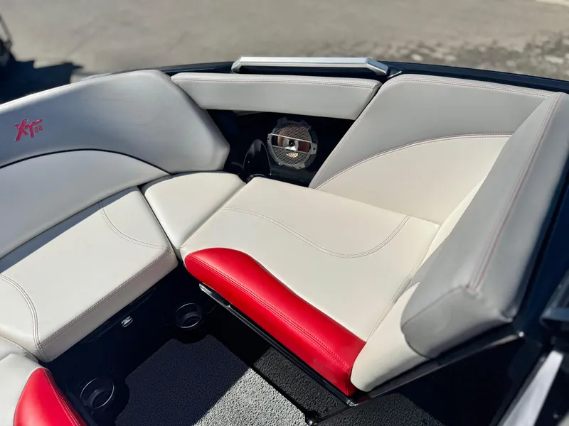 Slide: The Image of 2018 MasterCraft XT22 boat interior with white and red seating, featuring a speaker. - 17