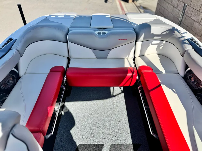 Slide: The Image of 2018 MasterCraft XT22 boat interior with red and white seating. - 19