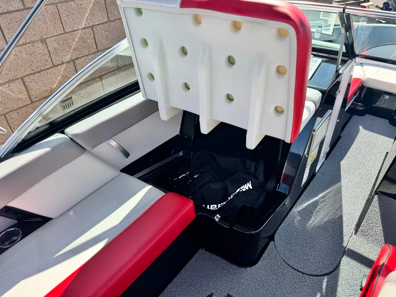 Slide: The Image of 2018 MasterCraft XT22 boat interior with red and white seating and storage compartment. - 26