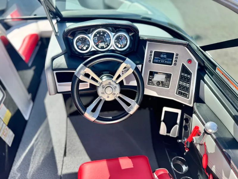 Slide: The Image of 2018 MasterCraft XT22 boat dashboard with steering wheel and control panel. - 29