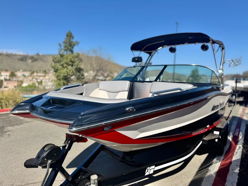 Slide: The Image of 2018 MasterCraft XT22 boat on trailer, featuring sleek design and modern features. - 3