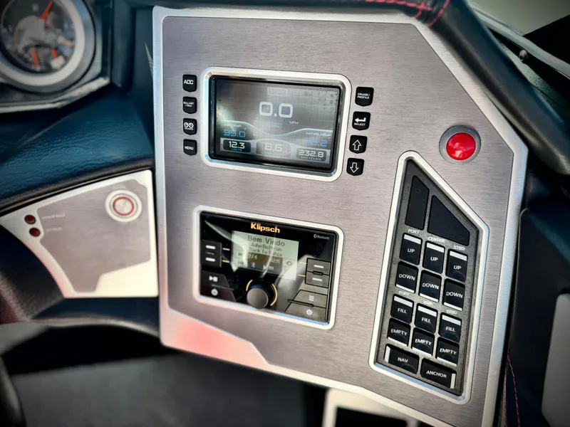 Slide: The Image of Control panel of a 2018 MasterCraft XT22 boat with digital display and audio system. - 31
