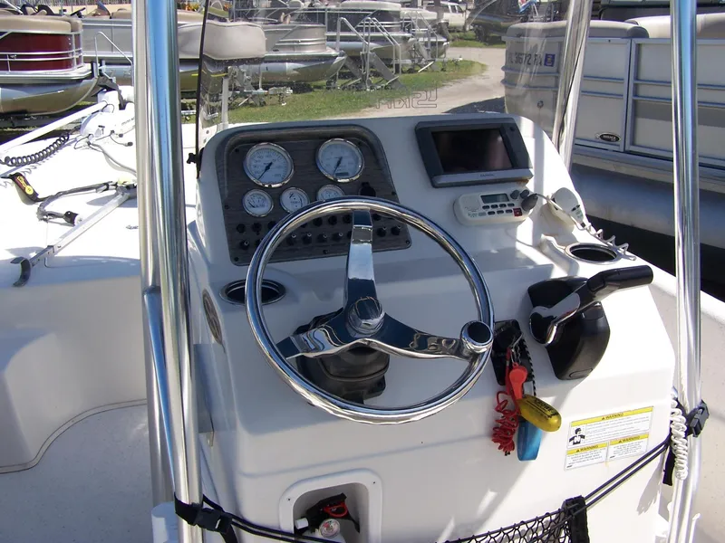 Slide: The Image of 2014 Carolina Skiff DLV 218 boat console with steering wheel and gauges. - 12