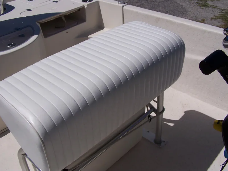 Slide: The Image of White cushioned seat on 2014 Carolina Skiff DLV 218 boat, featuring ribbed upholstery design. - 14