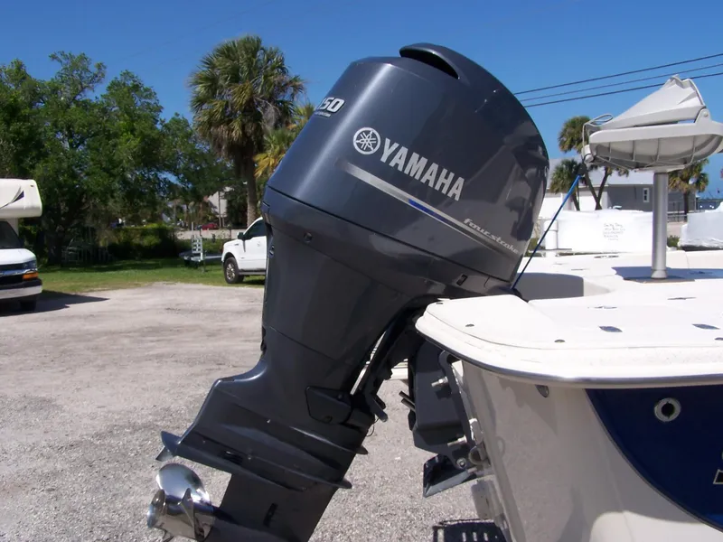 Slide: The Image of 2014 Carolina Skiff DLV 218 with Yamaha outboard motor in a sunny outdoor setting. - 4