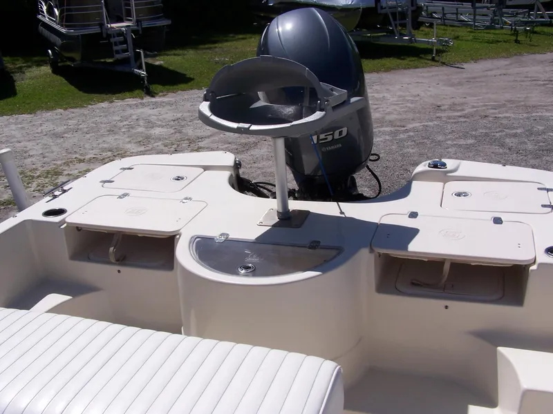 Slide: The Image of 2014 Carolina Skiff DLV 218 boat interior with Yamaha 150 engine, featuring storage compartments. - 9