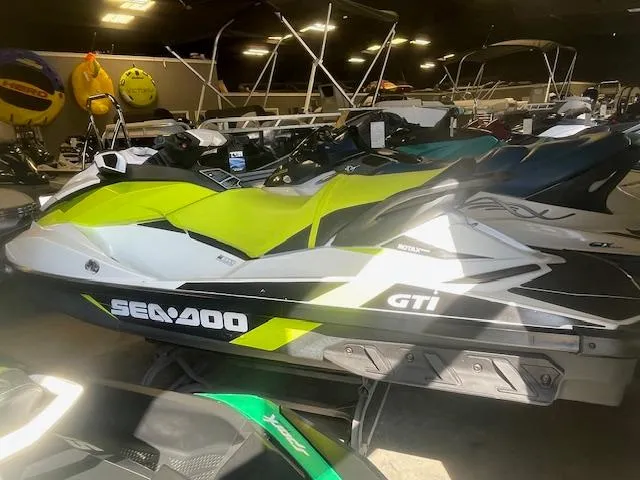 Slide: The Image of 2017 Sea-Doo GTI jet ski in showroom, featuring vibrant yellow and black design. - 6