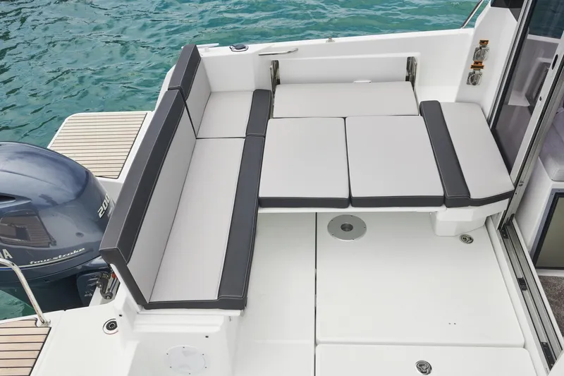 Slide: The Image of 2025 Jeanneau NC795 S2 boat with spacious seating area and modern design. - 10