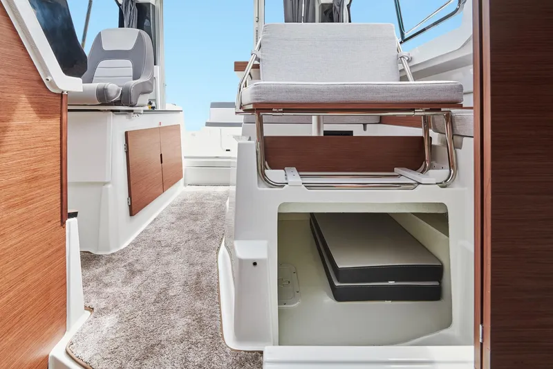 Slide: The Image of 2025 Jeanneau NC795 S2 interior with seating, storage, and modern design elements. - 17