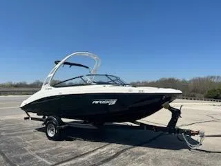 Slide: The Image of 2025 Yamaha Boats AR190 on trailer, parked outdoors under clear blue sky. - 2