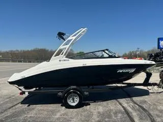 Slide: The Image of 2025 Yamaha Boats AR190 on trailer, parked outdoors under clear blue sky. - 4