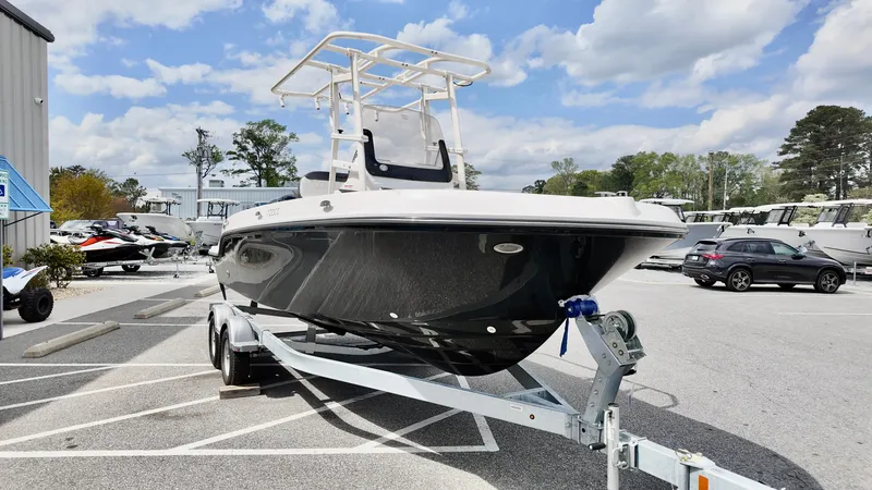 Slide: The Image of 2025 Bayliner Trophy 20 boat on trailer in parking lot under cloudy sky. - 12