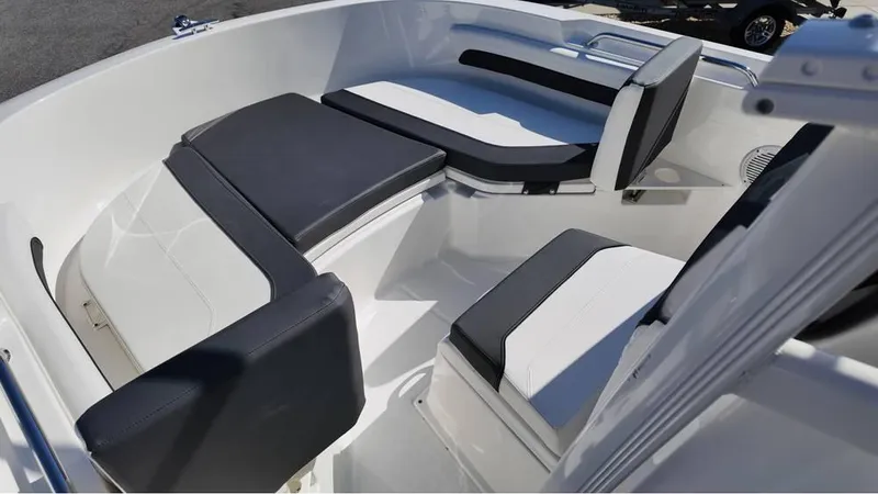 Slide: The Image of 2025 Bayliner Trophy 20 boat interior with cushioned seating and sleek design. - 5