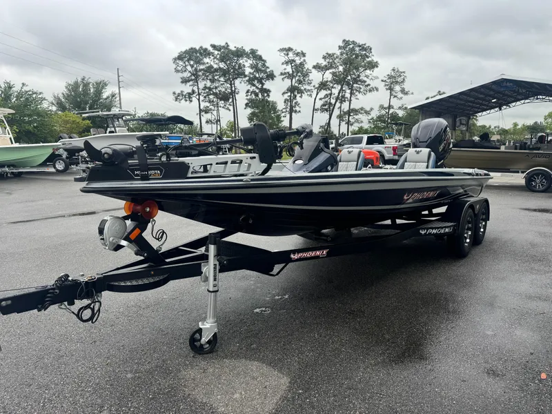 Slide: The Image of 2025 Phoenix 721 ZXL fishing boat on trailer in parking lot, overcast sky. - 1