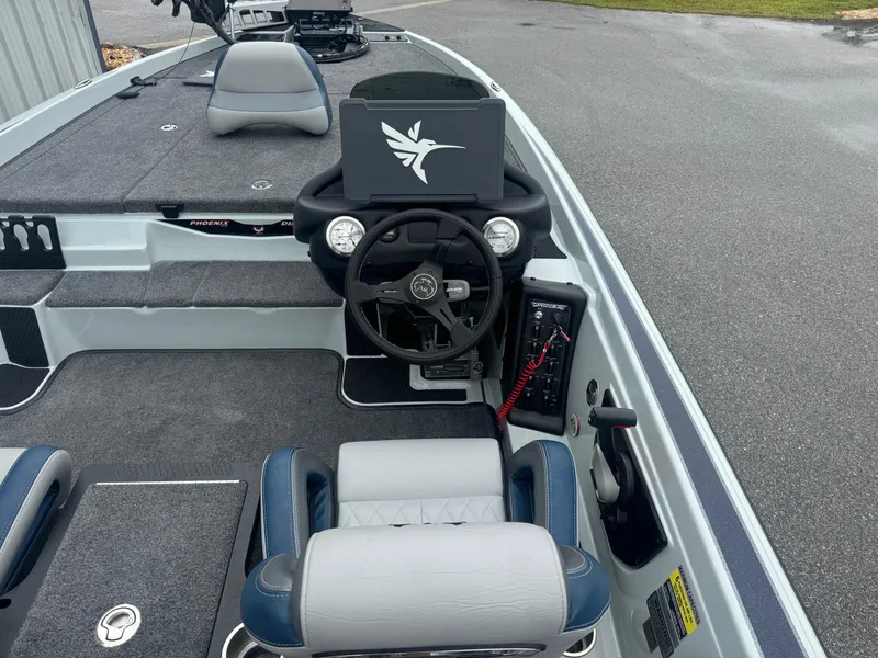 Slide: The Image of 2025 Phoenix 721 ZXL boat interior with steering wheel and seating. - 12