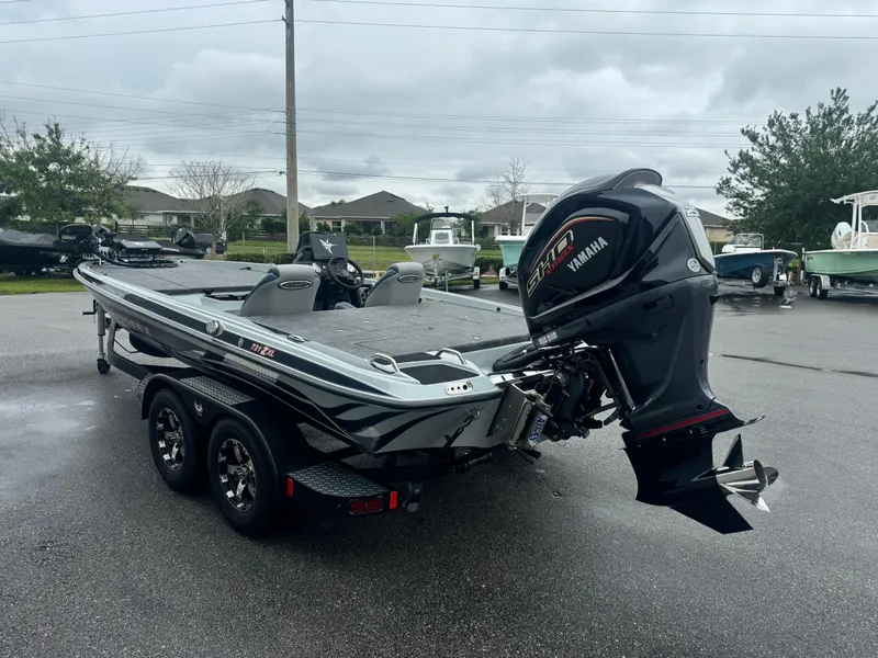 Slide: The Image of 2025 Phoenix 721 ZXL boat with Yamaha outboard motor on a trailer, parked outdoors. - 14