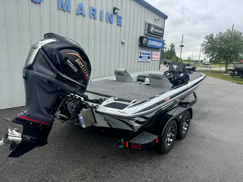 Slide: The Image of 2025 Phoenix 721 ZXL boat with powerful engine, parked outside marine dealership. - 15