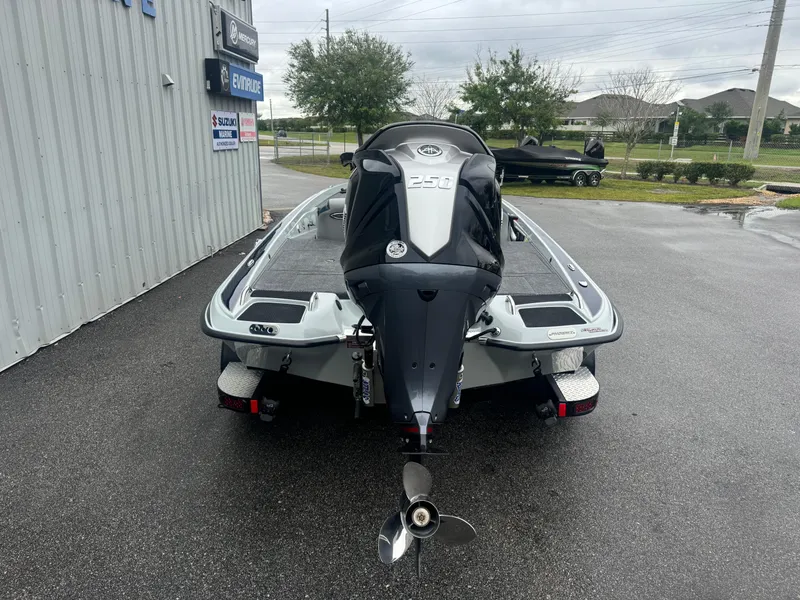 Slide: The Image of 2025 Phoenix 721 ZXL boat, rear view, parked outdoors on wet pavement. - 16
