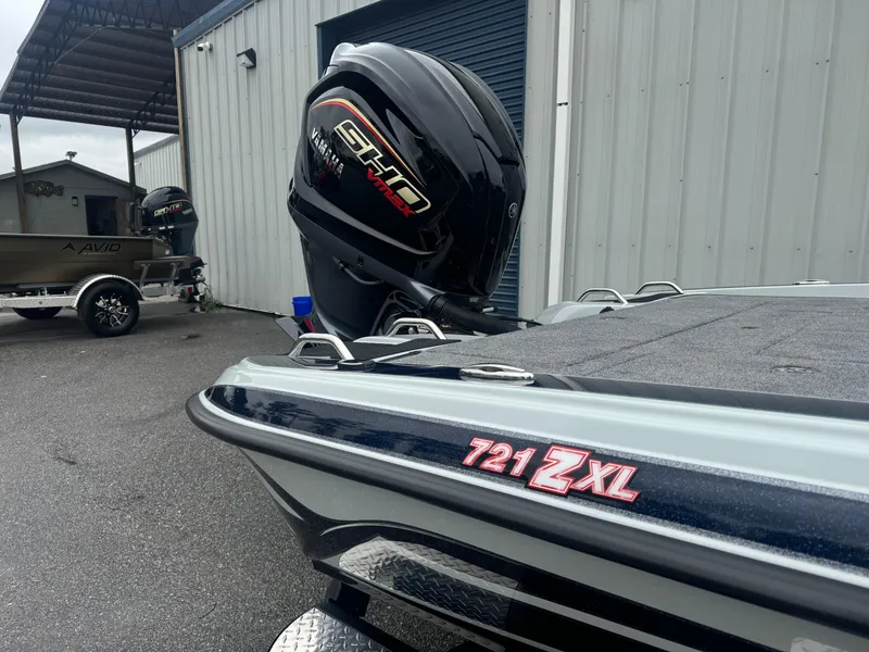 Slide: The Image of 2025 Phoenix 721 ZXL boat with powerful engine, parked near a metal building. - 4