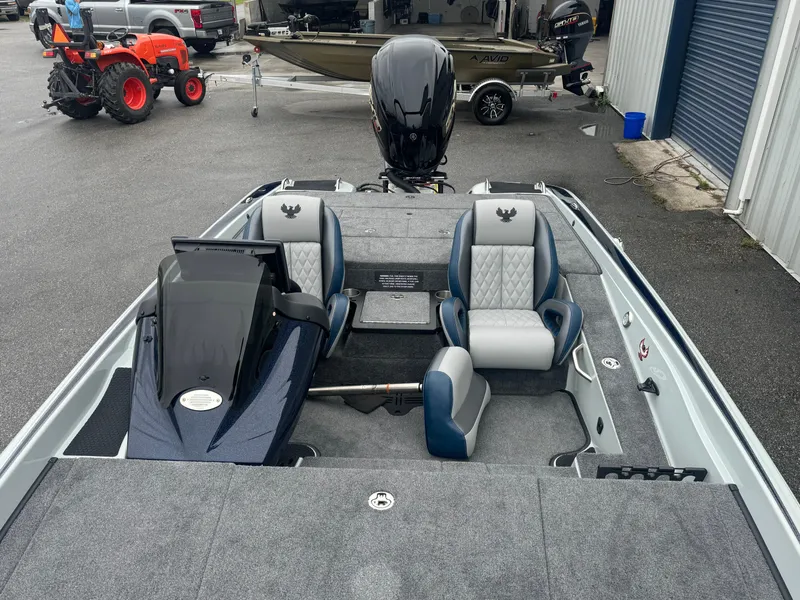Slide: The Image of 2025 Phoenix 721 ZXL boat with dual seats and sleek design in a showroom setting. - 9