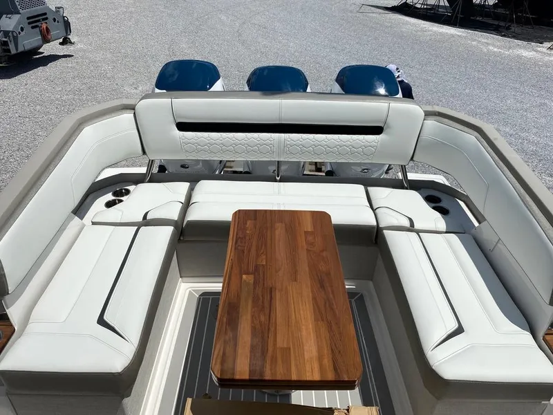 Slide: The Image of 2023 Tiara Sport 38 LS boat with luxurious seating and wooden table. - 10