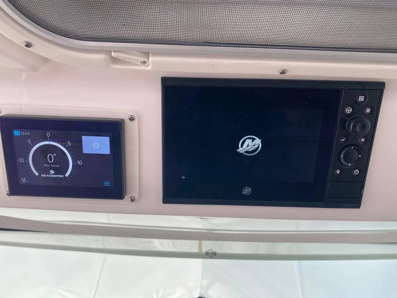 Slide: The Image of Control panel of 2023 Tiara Sport 38 LS boat with digital displays. - 14