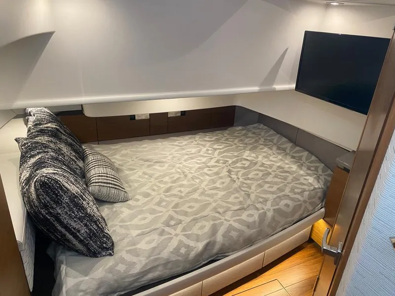 Slide: The Image of Luxurious cabin interior of 2023 Tiara Sport 38 LS with cozy bed and TV. - 15