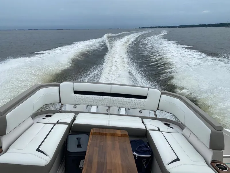 Slide: The Image of 2023 Tiara Sport 38 LS cruising on open water, showcasing luxurious seating and wake trail. - 17