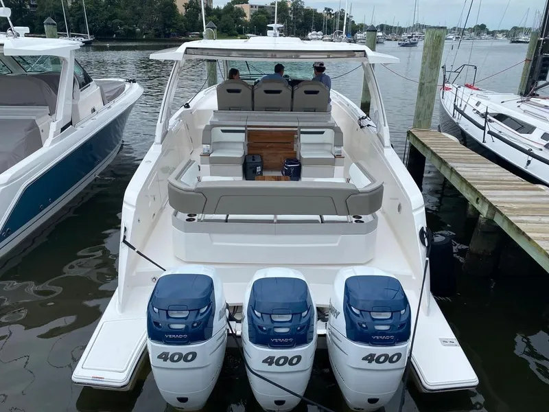 Slide: The Image of 2023 Tiara Sport 38 LS boat with triple 400 HP engines docked at marina. - 2