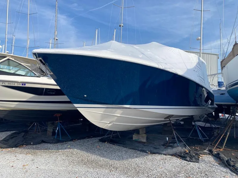 Slide: The Image of 2023 Tiara Sport 38 LS boat covered and docked in a marina. - 5