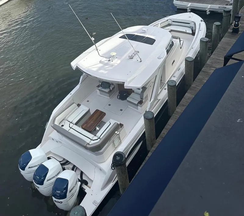 Slide: The Image of 2023 Tiara Sport 38 LS boat docked with twin outboard engines. - 7