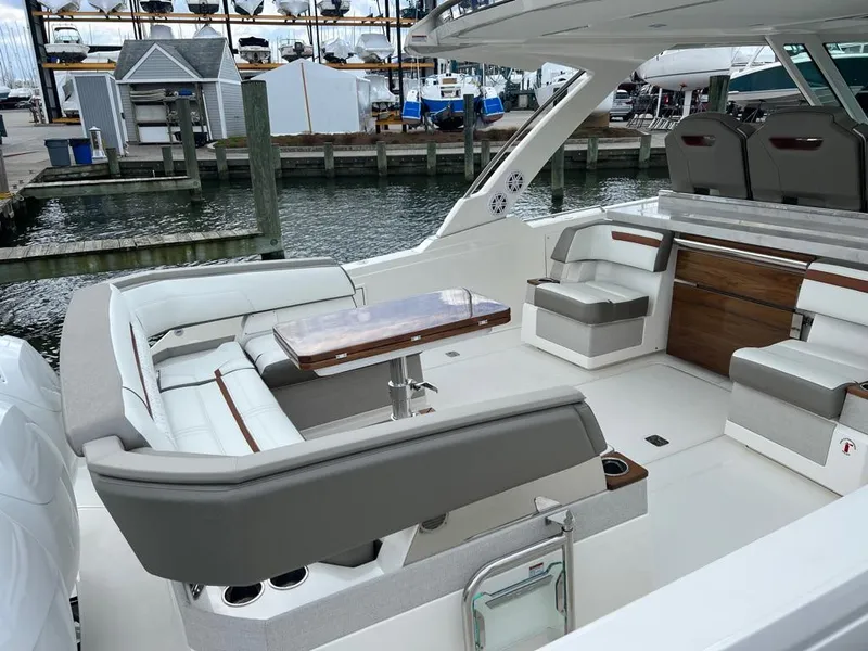 Slide: The Image of 2023 Tiara Sport 38 LS luxury yacht interior with elegant seating and wooden table. - 8