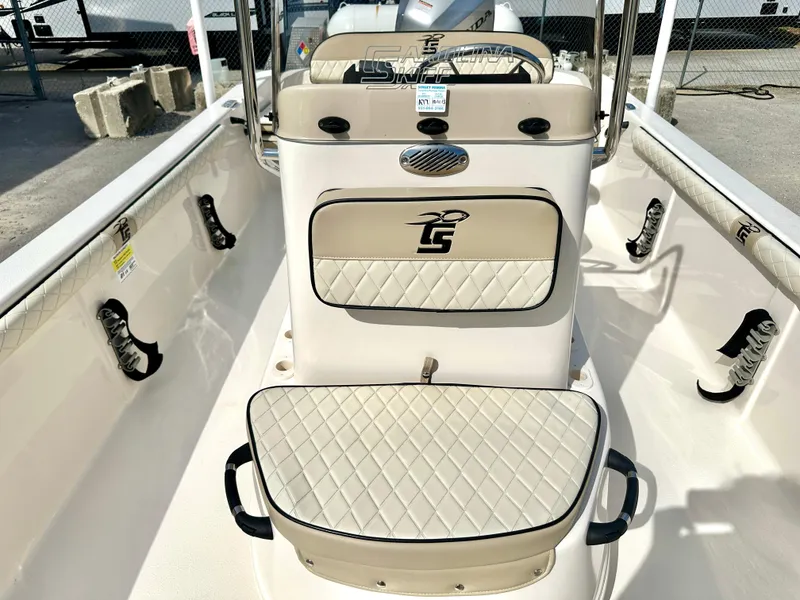 Slide: The Image of 2021 Carolina Skiff 21 LS boat interior with beige seating and steering console. - 11