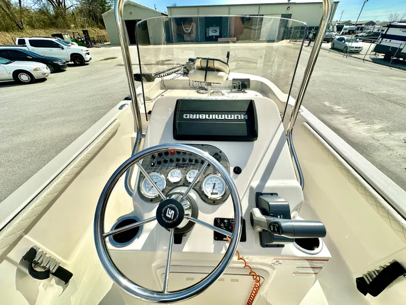 Slide: The Image of 2021 Carolina Skiff 21 LS boat dashboard with steering wheel and navigation system. - 12
